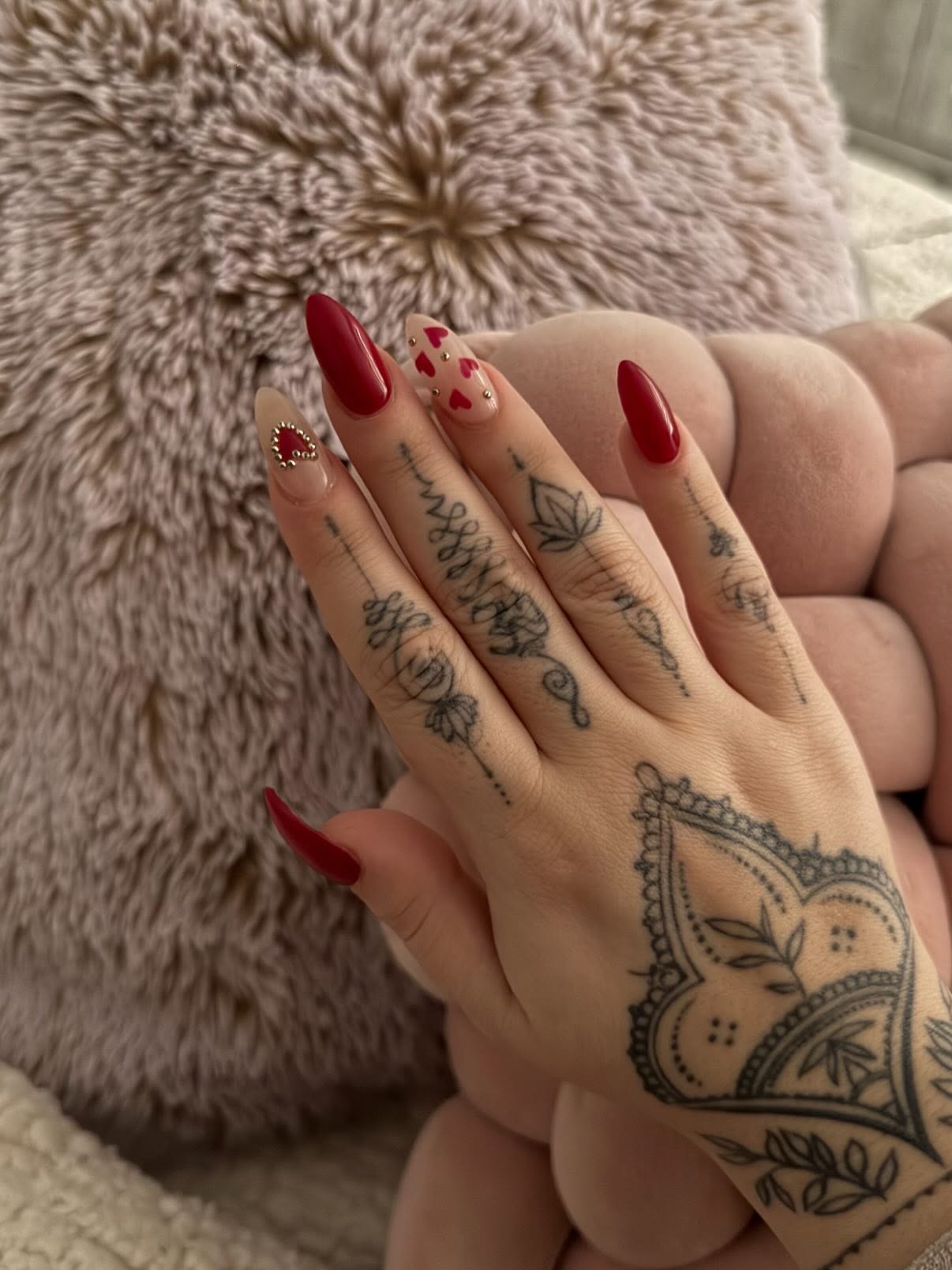 Elegant red almond nails and lash-ready styling at Aphrodite Beauty Salon