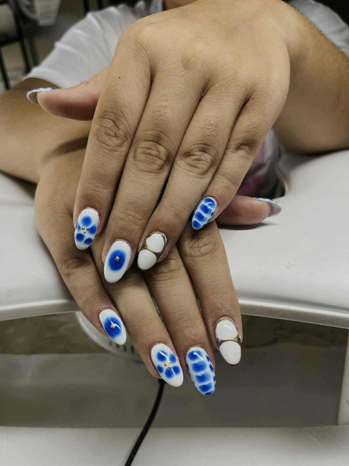 Soft blue and white nail artistry reflecting the calm treatment rooms at Aphrodite